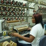 Worker operating advanced machinery in Fénix’s manufacturing facility