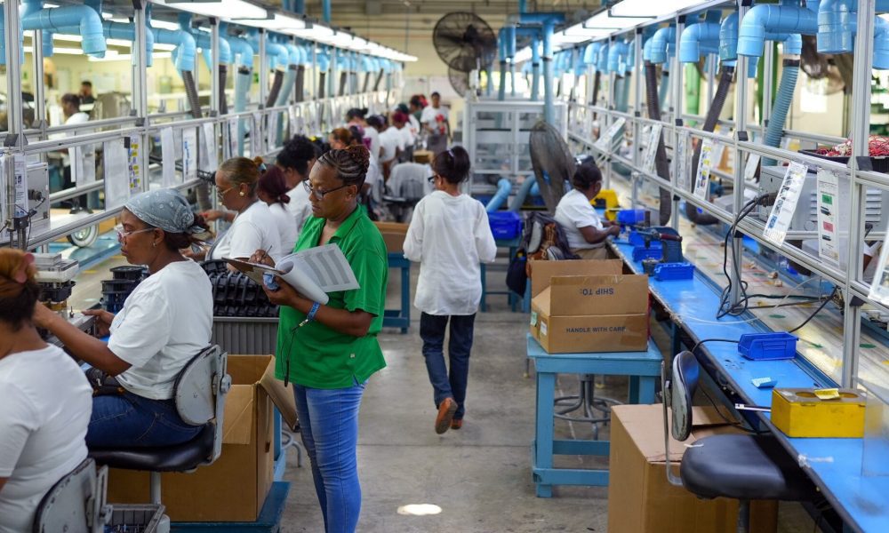 Workers assembling electromechanical components in Fénix's production area
