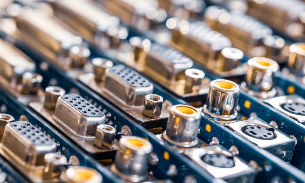 Close-up blurry metal sockets on a computer video board. Concept for the production of computer televisions and audio speakers