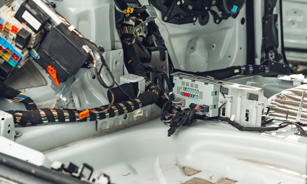 Electric wiring system with colorful wires in the car close up