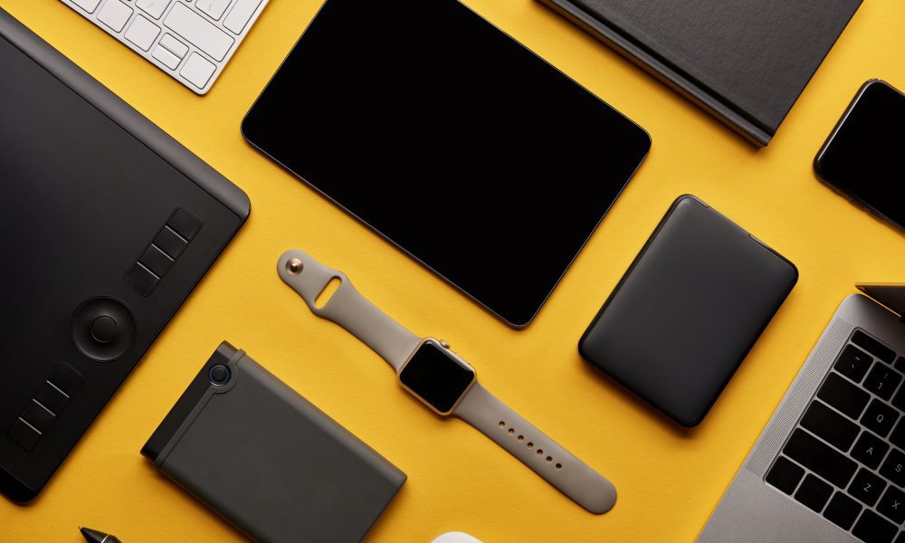 flat lay with different wireless devices on yellow surface