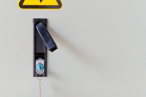A vertical shot of electrocution hazard icon sticker on power panel door