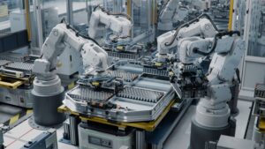 Robotic arms assembling components in an automated facility