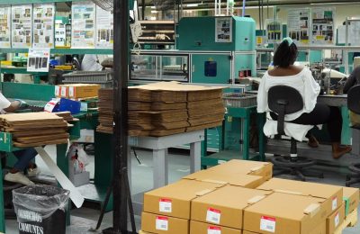 Workers operating machines in the circuit breakers assembly area at Fénix